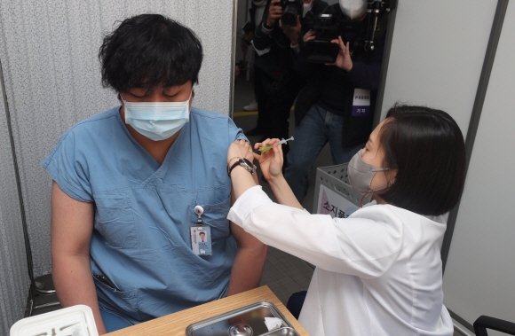 27일 오전 서울 중구 국립중앙의료원 중앙예방접종센터에서 한 의료 종사자가 화이자 백신을 맞고 있다. 이날 국립중앙의료원에서 의료진, 종사자 199명이 화이자 백신 1차 접종을 받는다. 2021.2.27  사진공동취재단